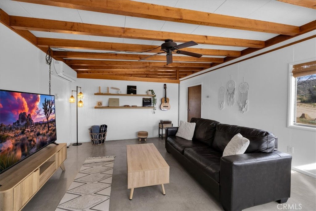 8500 South Samel Road Morongo Valley, CA 92256 - Photo 24 of 75 a living room with furniture and a flat screen tv