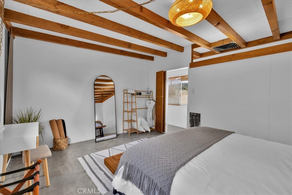 8500 South Samel Road Morongo Valley, CA 92256 - Photo 29 of 75 a bedroom with a bed a couch and dresser