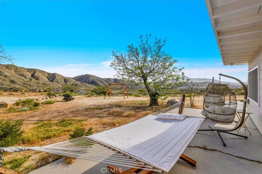 8500 South Samel Road Morongo Valley, CA 92256 - Photo 36 of 75 a view of a swimming pool with lounge chair