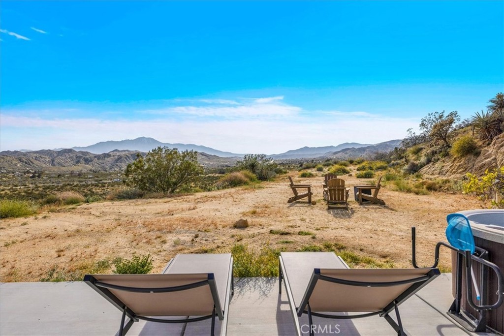 8500 South Samel Road Morongo Valley, CA 92256 - Photo 37 of 75 a view of a lake with a table and chairs