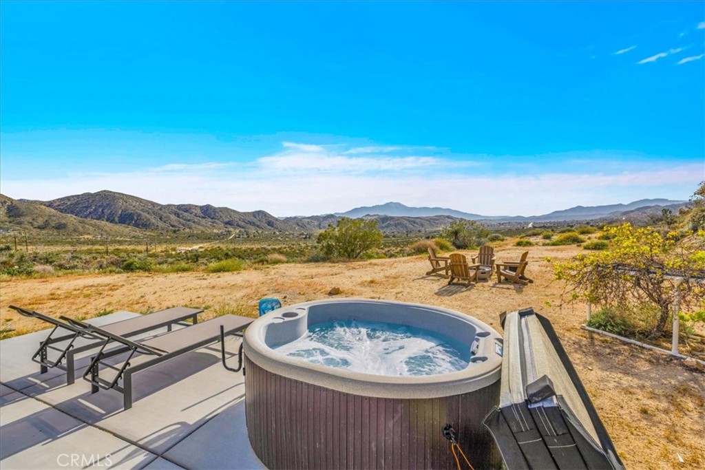 8500 South Samel Road Morongo Valley, CA 92256 - Photo 38 of 75 a view of a lake with a table and chairs