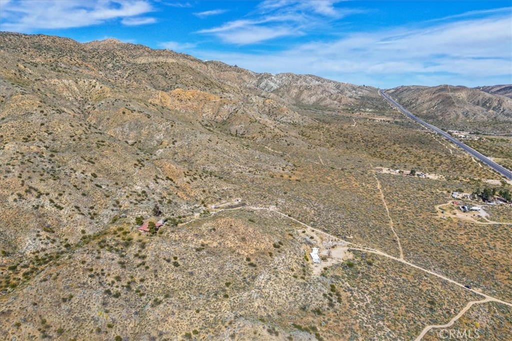 8500 South Samel Road Morongo Valley, CA 92256 - Photo 59 of 75 a view of a dry yard with mountains in the background