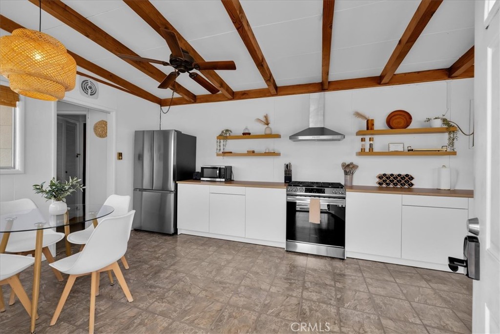 8500 South Samel Road Morongo Valley, CA 92256 - Photo 8 of 75 a kitchen with stainless steel appliances granite countertop a sink a stove and refrigerator