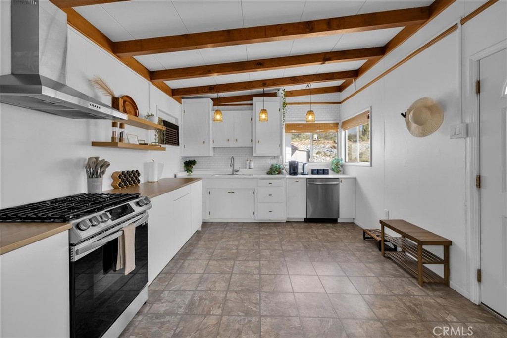 8500 South Samel Road Morongo Valley, CA 92256 - Photo 9 of 75 a kitchen with a sink a stove and cabinets