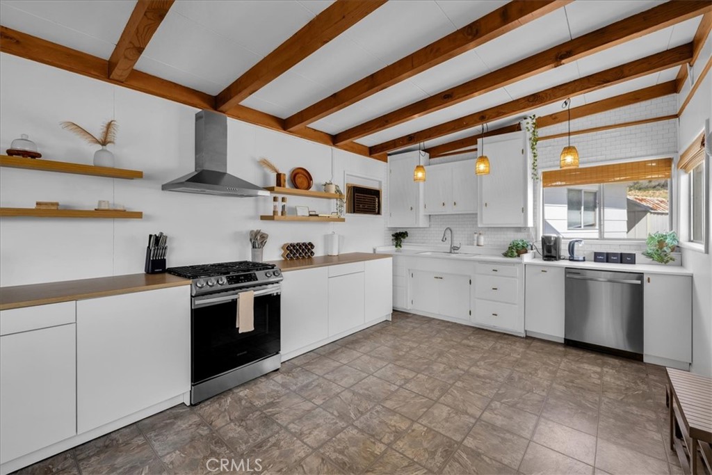 8500 South Samel Road Morongo Valley, CA 92256 - Photo 10 of 75 a kitchen with stainless steel appliances granite countertop a stove a sink and a refrigerator