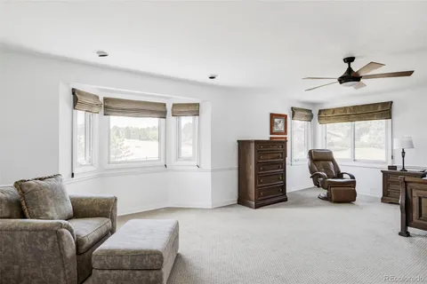 a spacious bedroom with a bed and a window