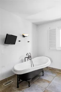 a bathroom with a bathtub and a toilet