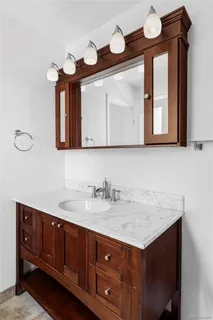 a bathroom with a double vanity sink and mirror