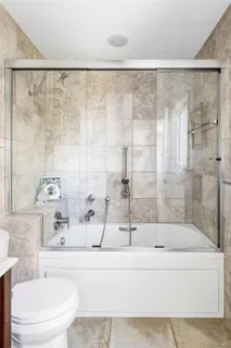 a bathroom with a bathtub and shower
