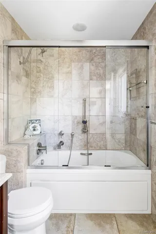 a bathroom with a bathtub and shower