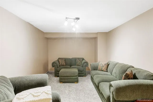 a dining room with furniture and large windows
