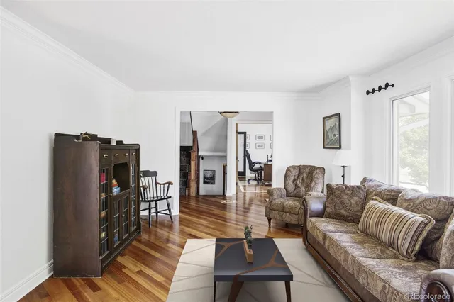 a kitchen with granite countertop wooden cabinets a sink and dishwasher a stove with wooden floor