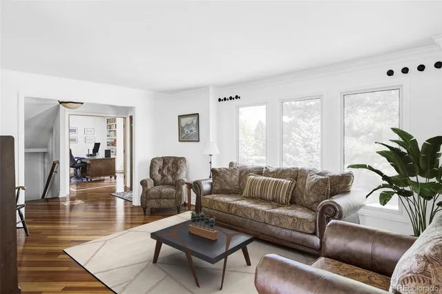 a kitchen with stainless steel appliances granite countertop a refrigerator a sink dishwasher a stove and white countertops with wooden floor