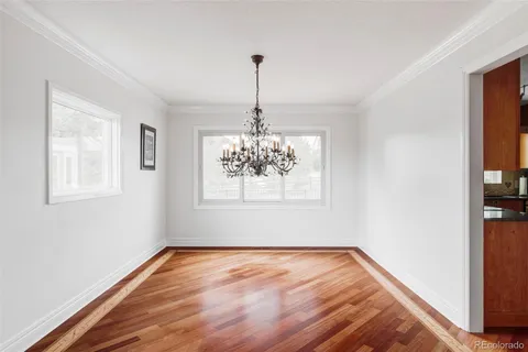 a kitchen with granite countertop wooden cabinets a sink and dishwasher a stove with wooden floor