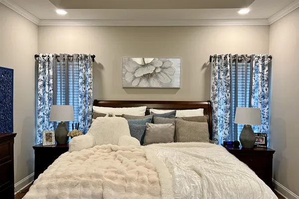 a living room with furniture and wall paintings