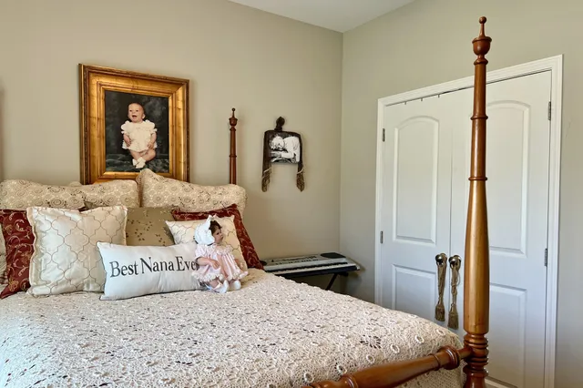 a bedroom with a bed and a dresser in it