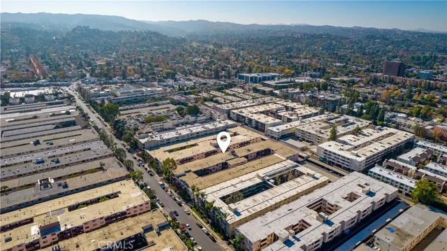 a car parked in front of a brick house with wooden fence