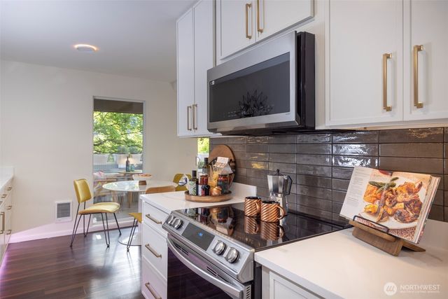a kitchen with a stove and a microwave