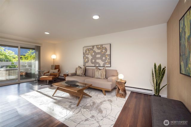 a living room with furniture and wooden floor