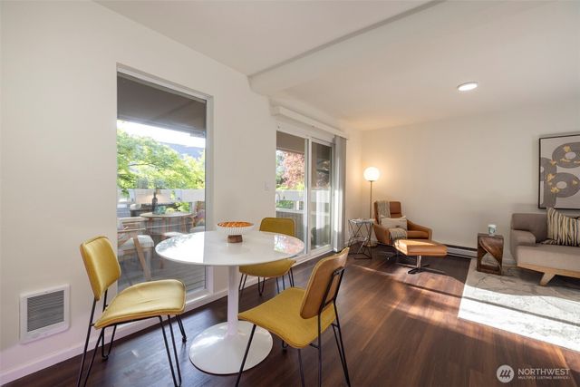 a dining room with furniture and wooden floor