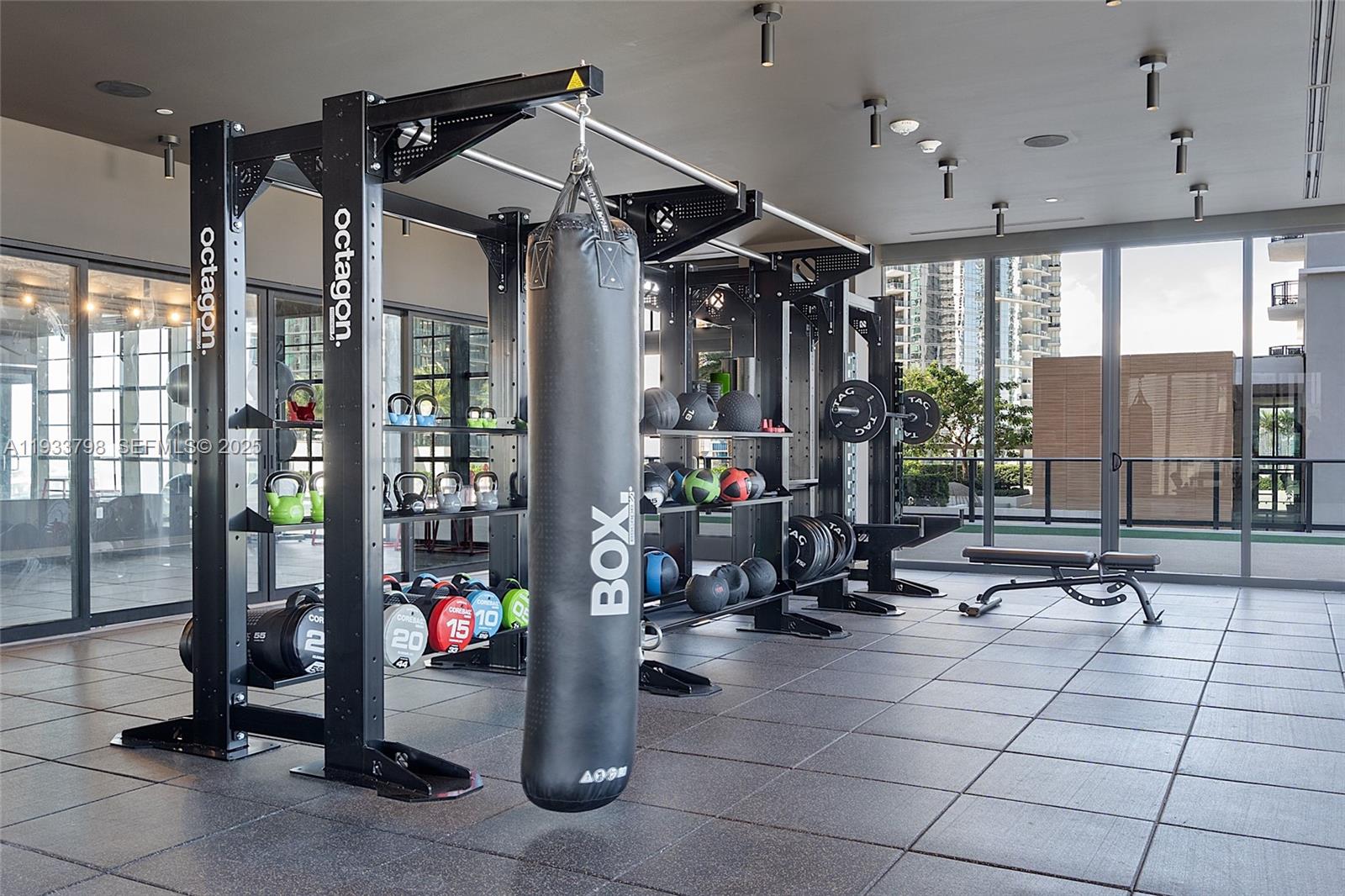 159 Northeast 6th Street, Unit 5015 Miami, FL 33132 - Photo 38 of 59 a gym room with lots of gym equipment and a large window