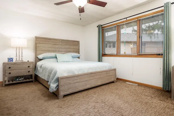 a bedroom with a bed and a dresser