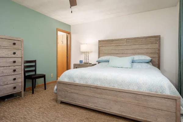 a bedroom with a bed and a chandelier