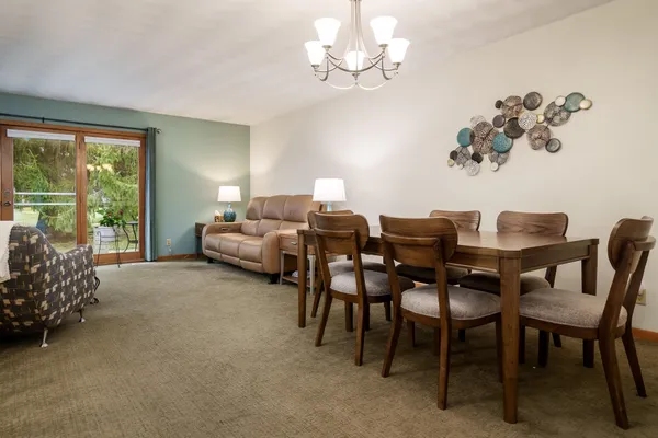 a view of a dining room with furniture and chandelier