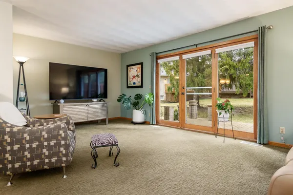 a living room with furniture and paintings on the wall
