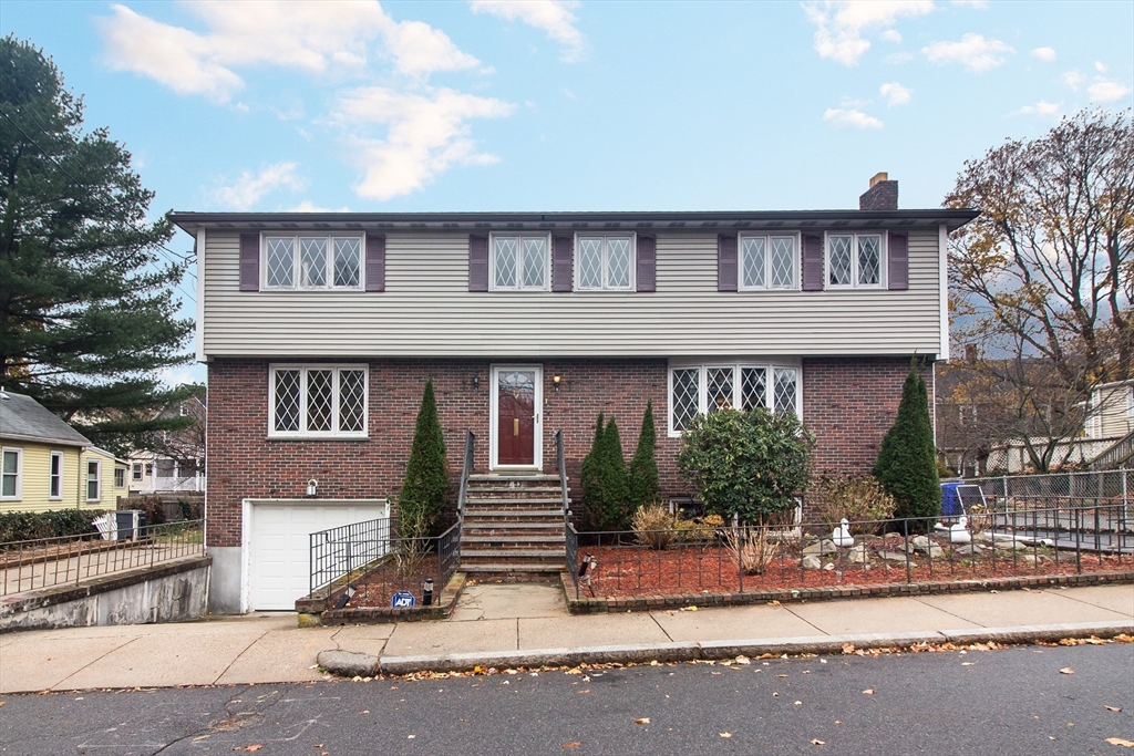 15 Rugdale Road Boston, MA 02124 - Photo 1 of 33 a front view of a house with garden