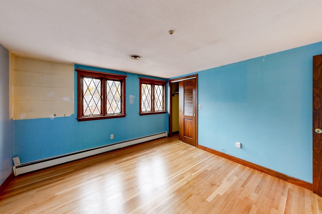 15 Rugdale Road Boston, MA 02124 - Photo 12 of 33 a view of an empty room with a window and wooden floor