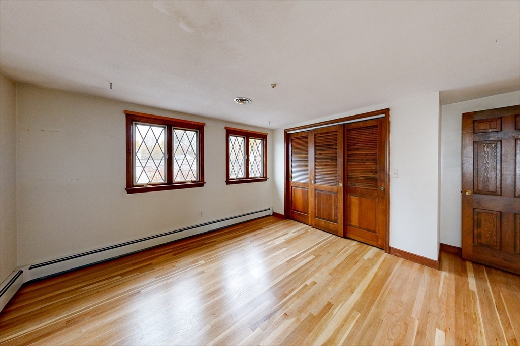 15 Rugdale Road Boston, MA 02124 - Photo 13 of 33 a view of an empty room with wooden floor and a window