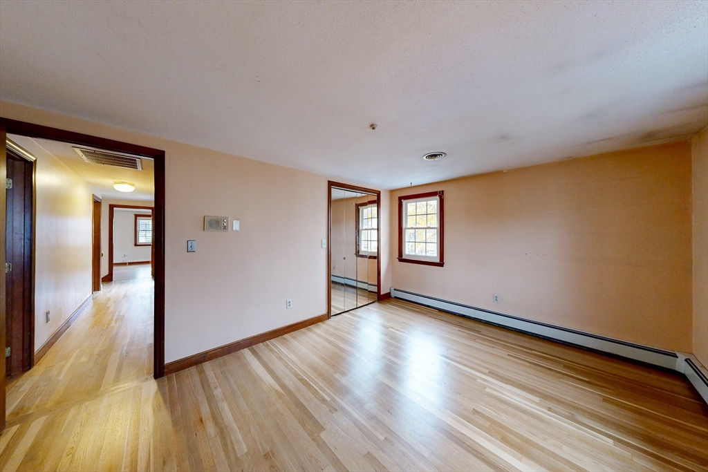 15 Rugdale Road Boston, MA 02124 - Photo 14 of 33 a view of an empty room with wooden floor and a window