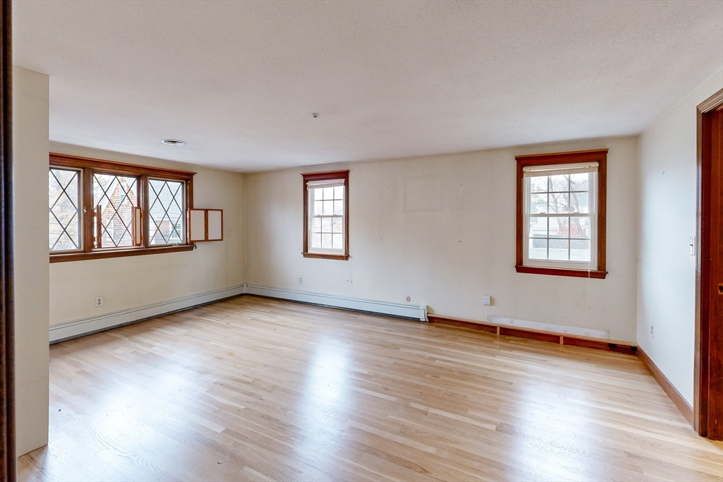 15 Rugdale Road Boston, MA 02124 - Photo 20 of 33 a view of an empty room with wooden floor and a window