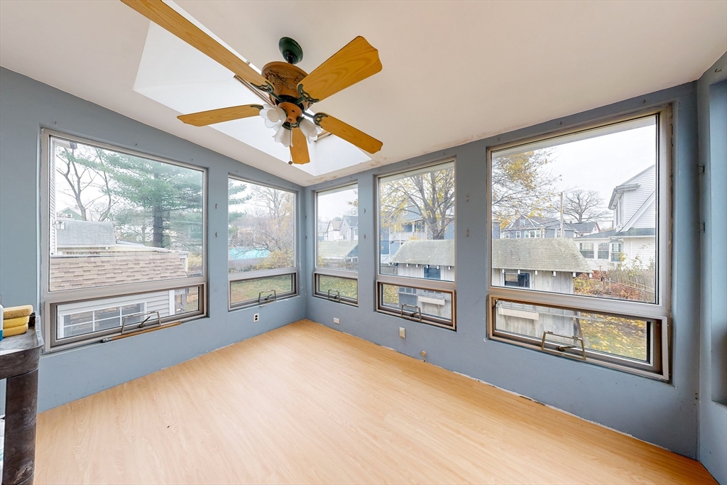 15 Rugdale Road Boston, MA 02124 - Photo 22 of 33 a view of an empty room with a window and kitchen view
