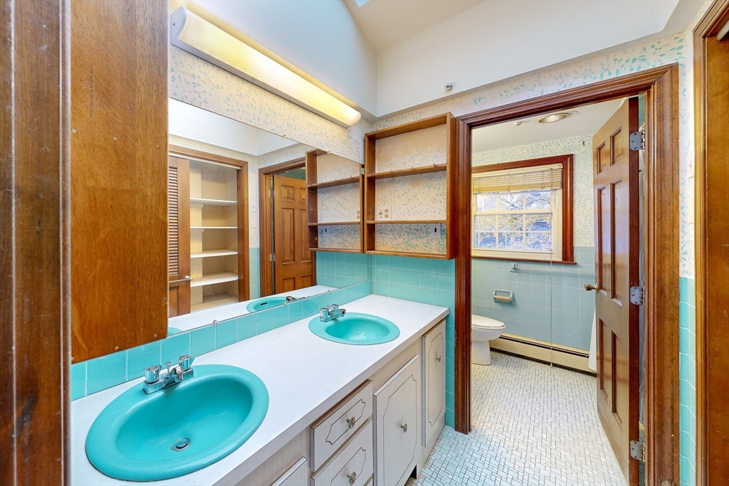 15 Rugdale Road Boston, MA 02124 - Photo 23 of 33 a bathroom with a granite countertop sink and a mirror