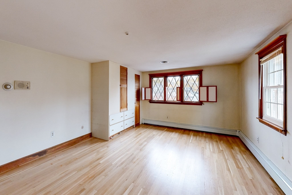 15 Rugdale Road Boston, MA 02124 - Photo 24 of 33 an empty room with wooden floor and windows