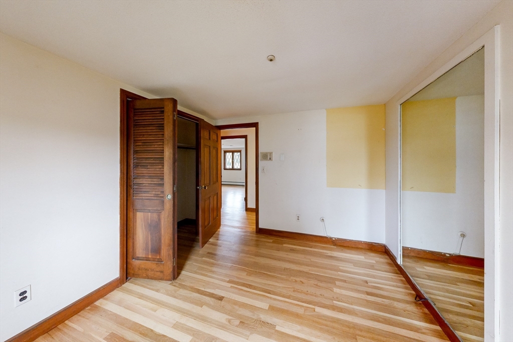 15 Rugdale Road Boston, MA 02124 - Photo 26 of 33 a view of an empty room with wooden floor and closet