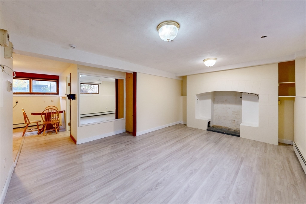 15 Rugdale Road Boston, MA 02124 - Photo 27 of 33 an empty room with wooden floor and windows