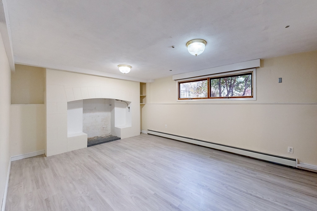 15 Rugdale Road Boston, MA 02124 - Photo 29 of 33 a view of an empty room with wooden floor and a window