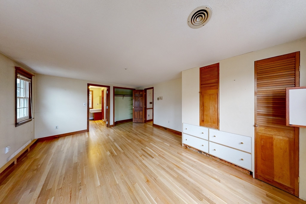 15 Rugdale Road Boston, MA 02124 - Photo 9 of 33 a view of an empty room with wooden floor and a window
