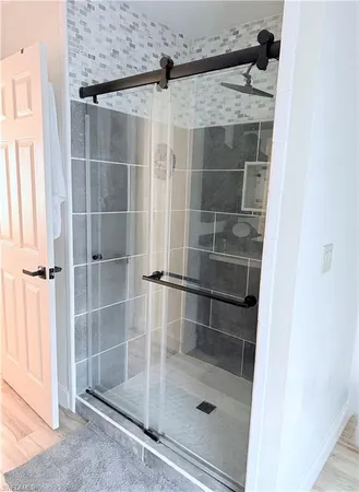 a bathroom with a glass shower door