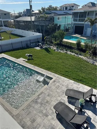 a view of a backyard with swimming pool