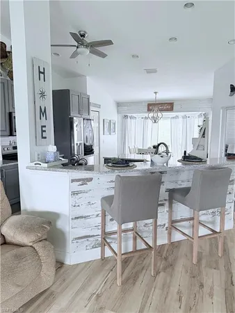 a kitchen with a table chairs refrigerator and cabinets