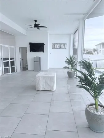 a living room with a couch and a potted plant
