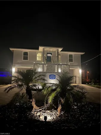 a front view of a house with lots of potted plants