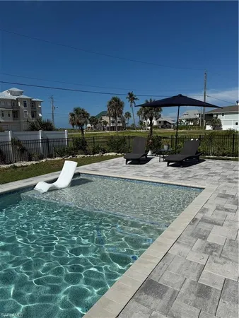 a view of a swimming pool with a patio