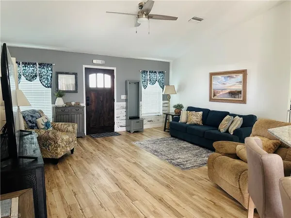 a living room with furniture and a wooden floor