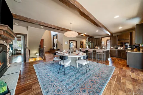 a view of a dining hall with lots of furniture and wooden floor