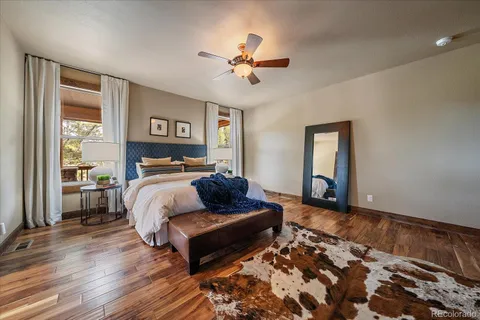 a spacious bathroom with a double vanity sink a large mirror a bathtub and next to a window